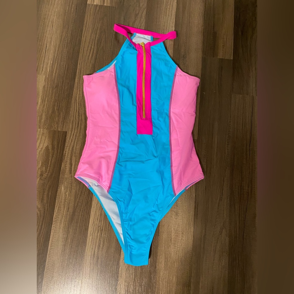 Small Barbie pink one piece swimsuit from Amazon. Never worn.